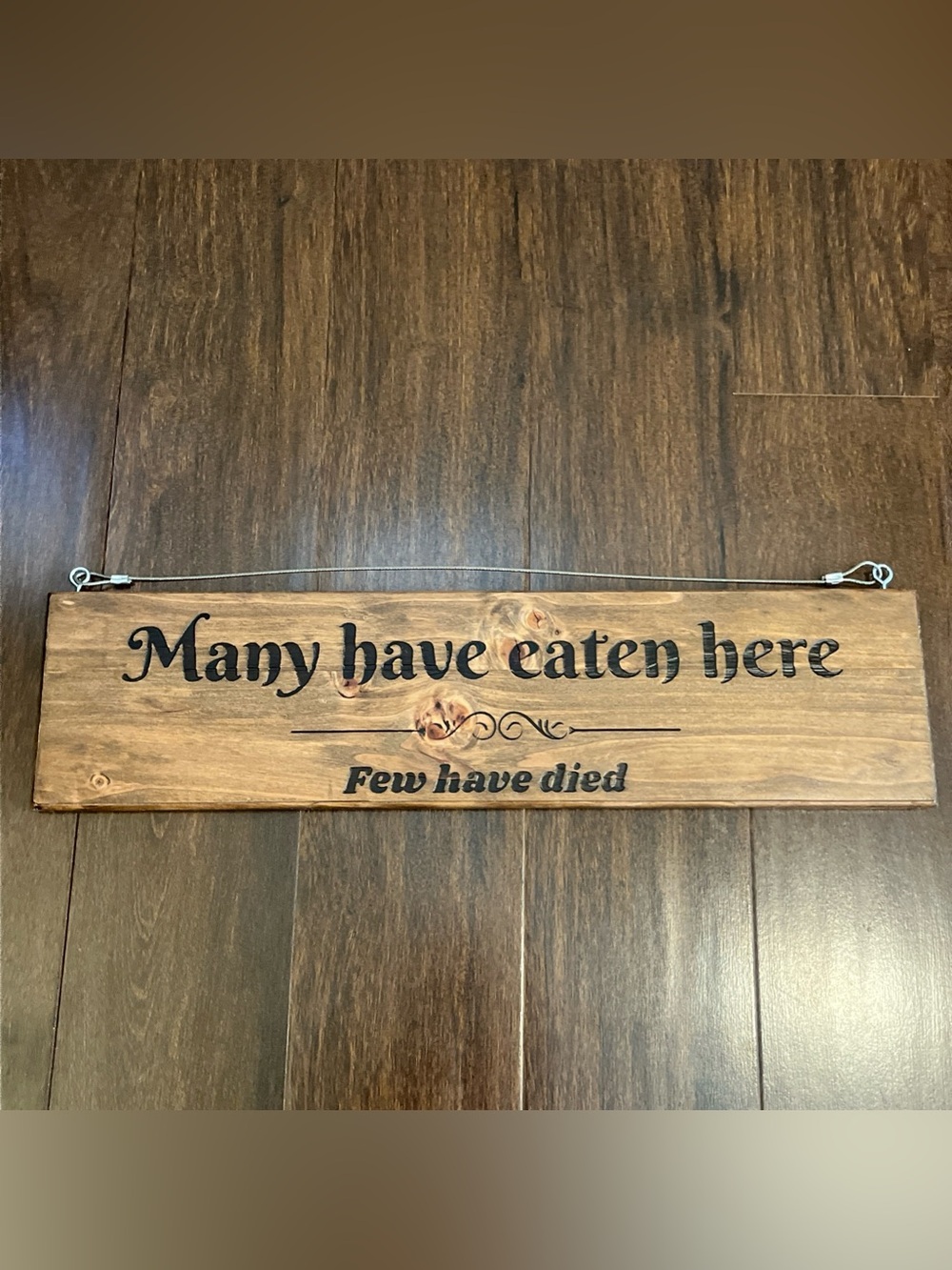 Rustic Wood Wall Sign — "Many have eaten here" in Black Lettering